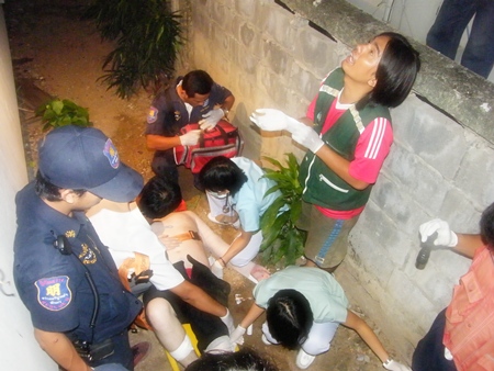 Emergency workers tend to the injured man, as one looks up to see how far the Aussie has fallen.